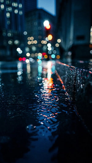 Moody Night Cityscape with Bokeh Lights Reflecting on Wet Pavement HD phone wallpaper