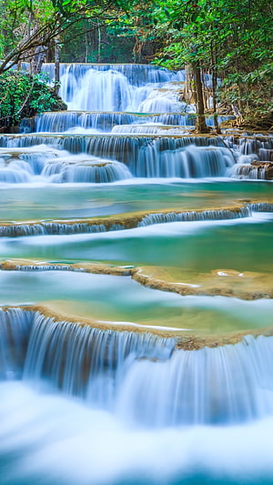Tiered Cascade Waterfall Flowing Through Lush Green Forest with Turquoise Pools HD phone wallpaper