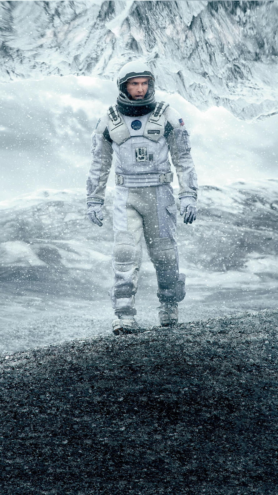 Interstellar astronaut walking through a snowy alien landscape in a white spacesuit HD phone wallpaper