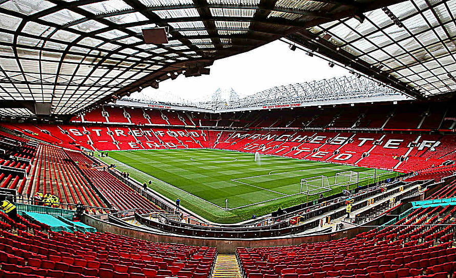Old Trafford Stadium Interior View with Manchester United Red Seating and Pitch HD wallpaper