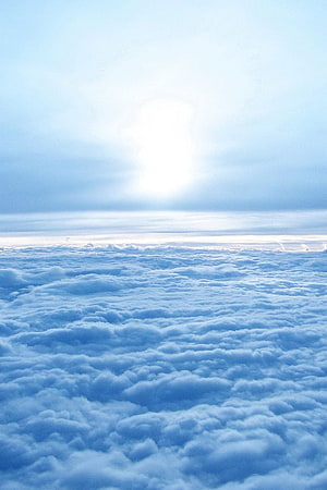Serene Sea of Clouds with Bright Sunlight Breaking Through the Sky HD phone wallpaper