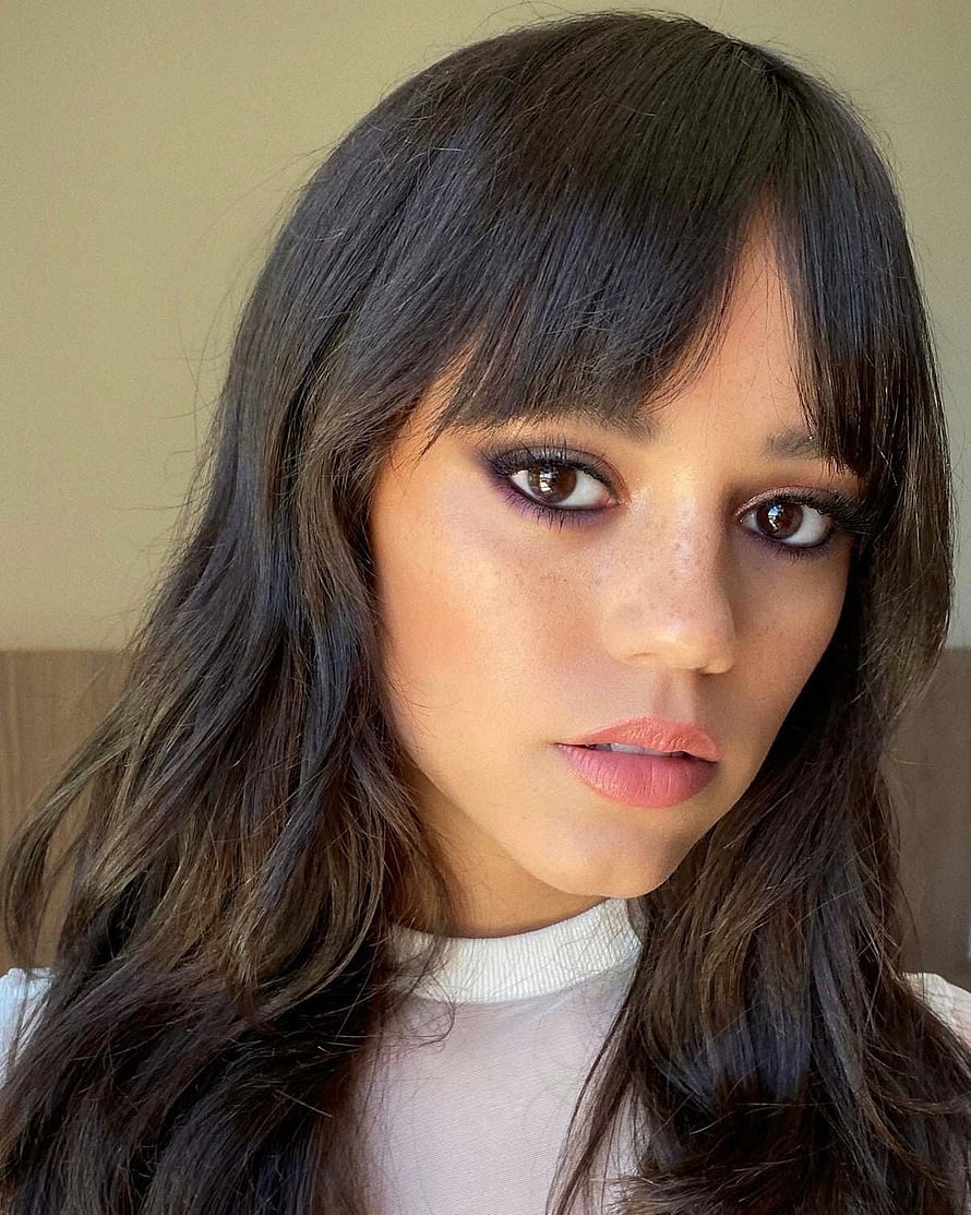 Jenna Ortega Close-Up Portrait With Dark Wavy Hair And Bangs HD phone wallpaper