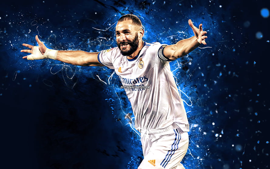 Karim Benzema in Real Madrid kit celebrating with arms wide against a blue neon particle background HD wallpaper