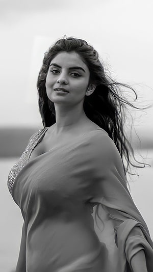 Anveshi Jain in a flowing saree with wind-blown hair in a monochrome portrait HD phone wallpaper