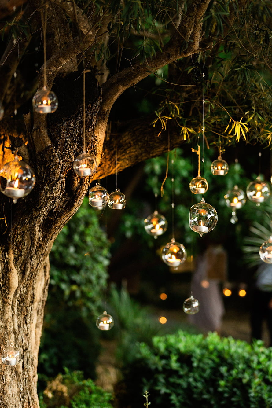 Glass Candle Ornaments Hanging From Tree Branches in a Garden at Night HD phone wallpaper
