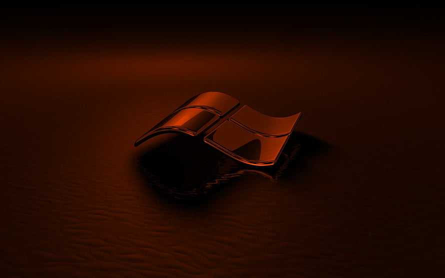 Glossy Bronze Windows Emblem Resting on Dark Rippled Surface HD wallpaper
