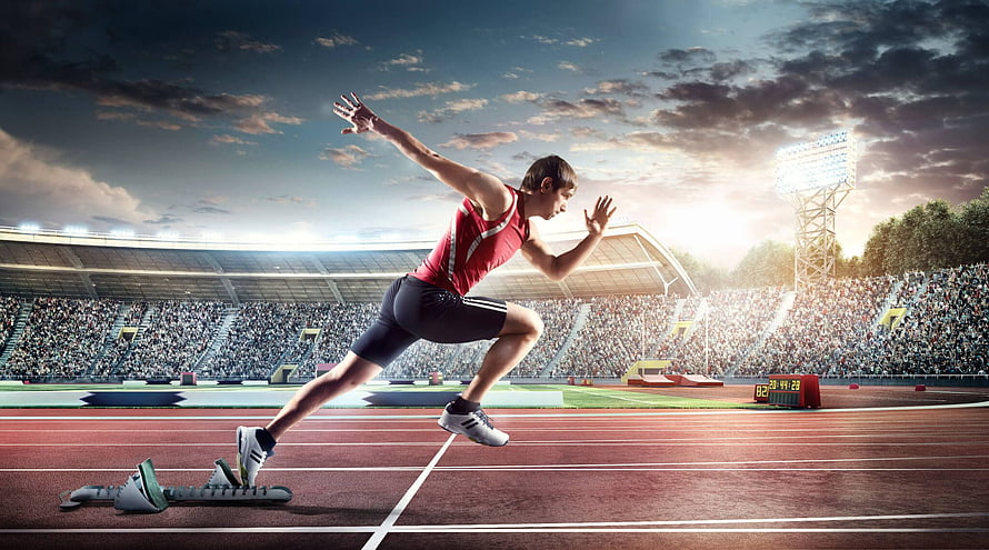 Sprinter Leaping Over Starting Blocks in Stadium at Sunset HD wallpaper