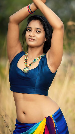 Soumya Shetty in a blue crop top and colorful traditional skirt with beaded necklace HD phone wallpaper
