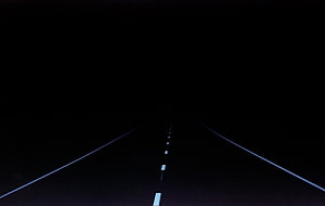 Dark Road at Night with White Lane Markers Disappearing into the Void HD wallpaper