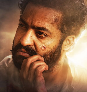 Intense Close-Up Portrait of Komaram Bheem from RRR with Dramatic Warm Lighting HD phone wallpaper