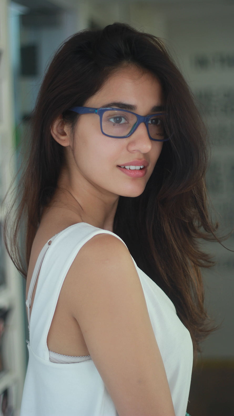 Portrait of Disha Patani Wearing Blue Glasses and White Top HD phone wallpaper