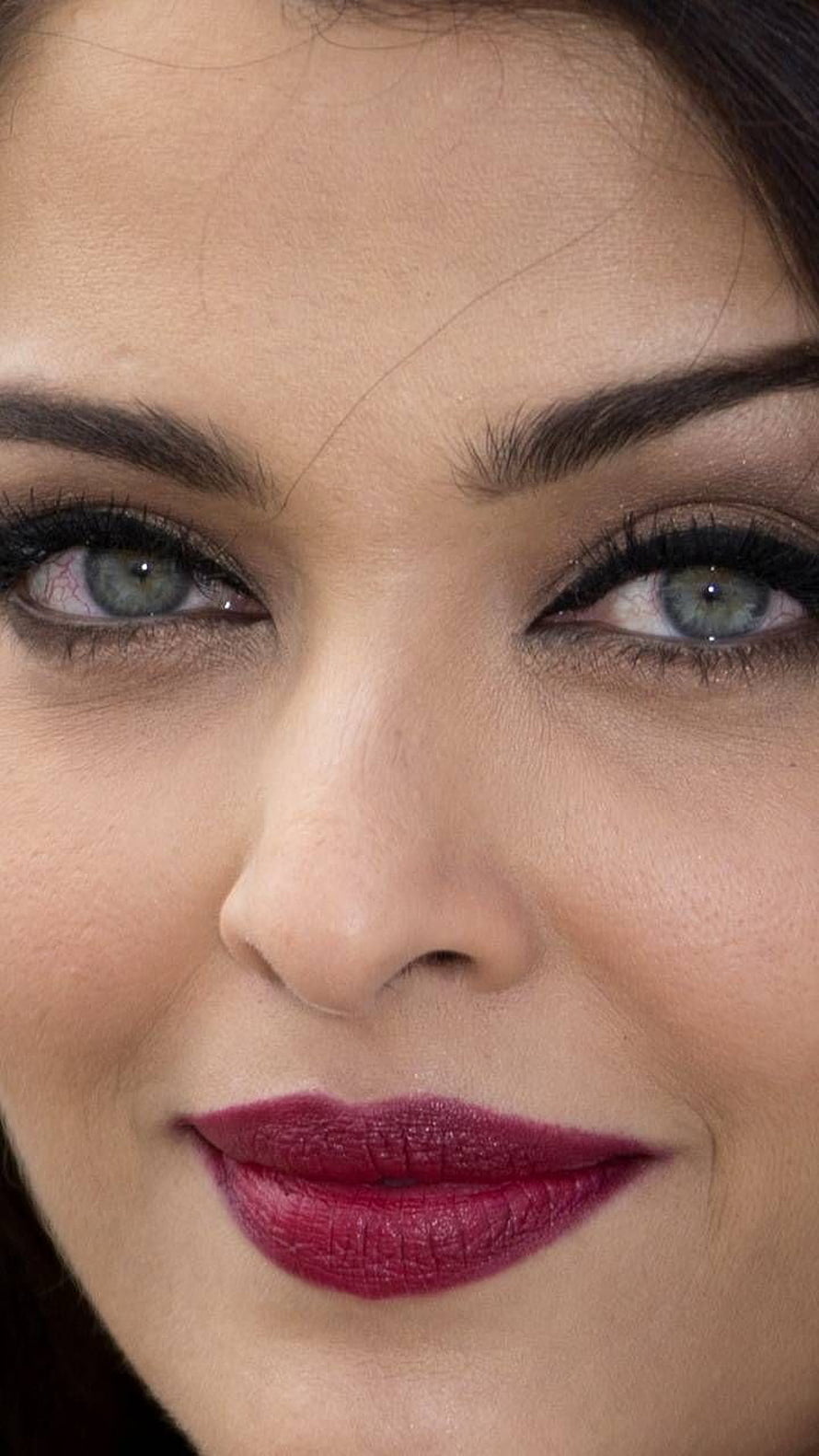Aishwarya Rai Close-Up Portrait with Bold Red Lipstick and Smoky Eye Makeup HD phone wallpaper