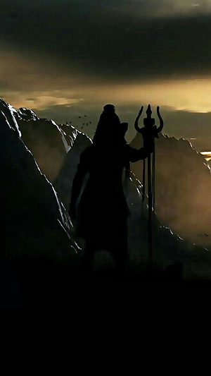 Silhouette of Shiva Holding Trishul Against Dramatic Mountain Sunset Sky HD phone wallpaper