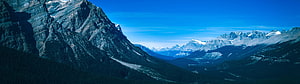 Majestic Rocky Mountain Peaks and Deep Forest Valley Under Clear Blue Sky HD wallpaper