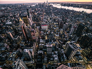 Aerial View of New York City Skyline at Sunset with Illuminated Skyscrapers and River HD wallpaper
