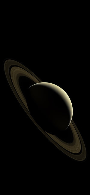 Saturn with its iconic rings set against the deep black void of outer space HD phone wallpaper