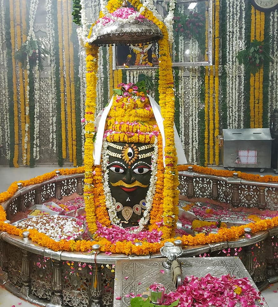 Sacred Kala Bhairava Idol Adorned With Marigold Garlands And Silver Umbrella In Temple HD phone wallpaper
