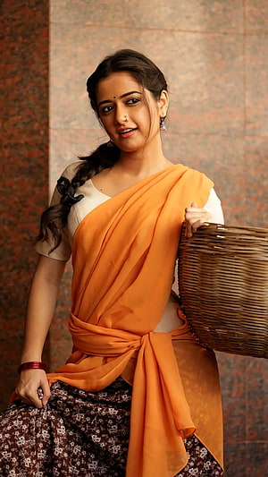 Ashika Ranganath in Traditional Orange Saree with Wicker Basket HD phone wallpaper