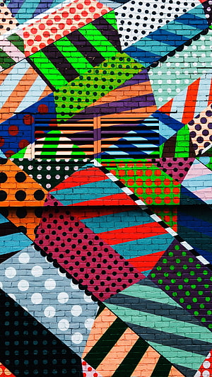 Vibrant Geometric Mural on Brick Wall with Polka Dots and Stripes HD phone wallpaper