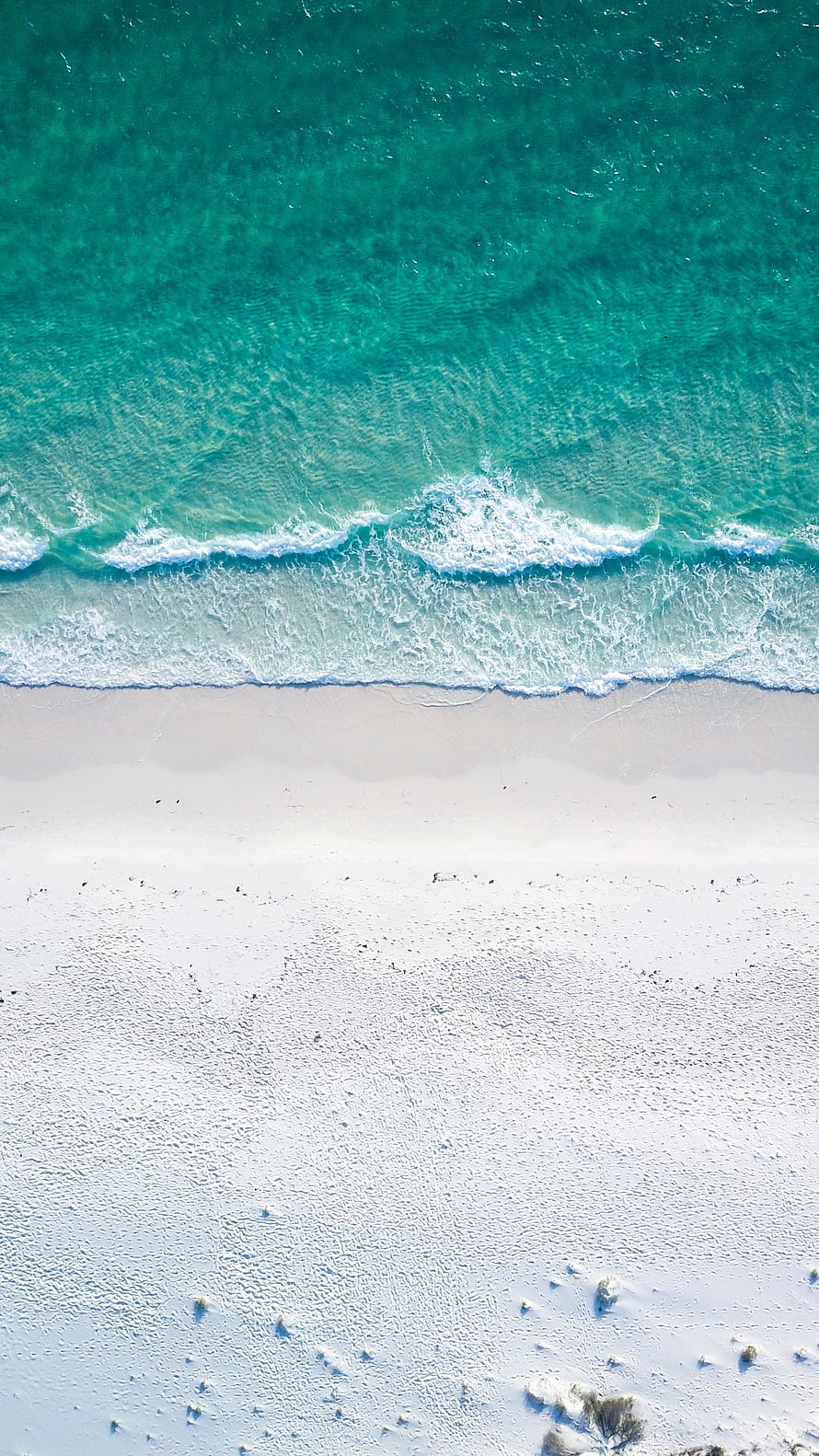 Aerial View of Turquoise Ocean Waves Meeting White Sandy Beach Shoreline HD phone wallpaper