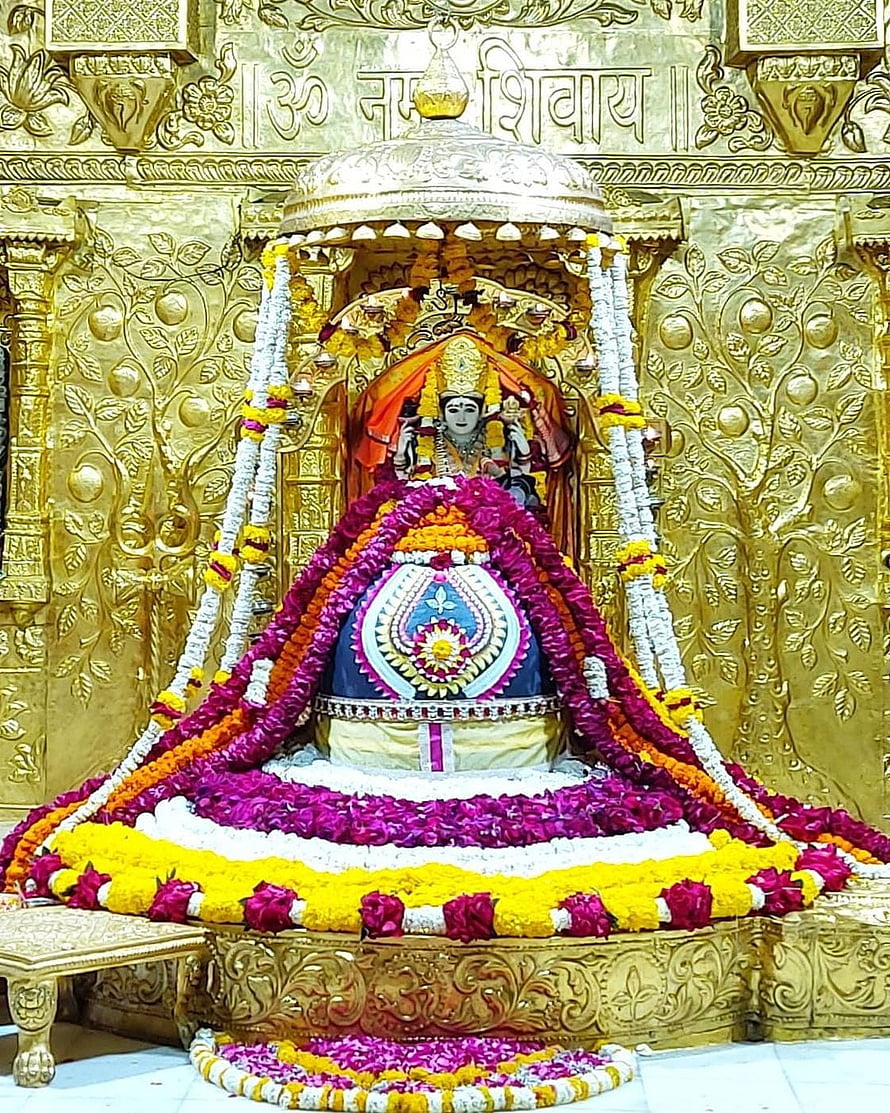 Somnath Mahadev Jyotirlinga adorned with vibrant floral garlands and golden temple architecture HD phone wallpaper