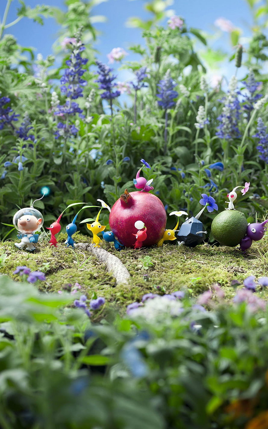 Pikmin Characters Gathered Around a Pomegranate in a Lush Garden Setting HD phone wallpaper