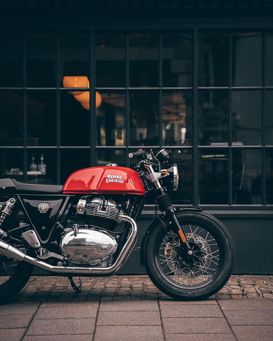 Red Royal Enfield Classic Motorcycle Parked on Cobblestone Street HD phone wallpaper