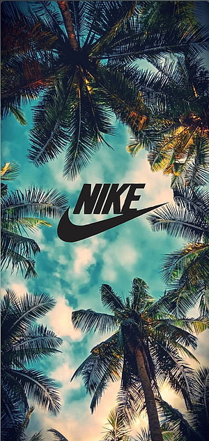 Nike Logo Centered Amongst Tropical Palm Trees Against Blue Sky HD phone wallpaper