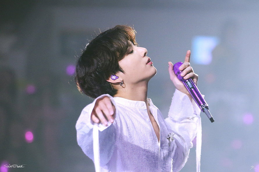 Jungkook of BTS performing on stage in a white textured shirt holding a purple microphone HD wallpaper