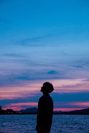 Man Silhouette Gazing at Vibrant Twilight Sky Over Calm Sea, Sunset, Sky, Sea, Dark, Silhouette, Guy HD phone wallpaper