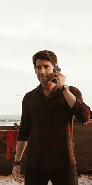 Mahesh Babu in a dark plaid shirt talking on a phone at the beach from Sarkaru Vaari Paata HD phone wallpaper