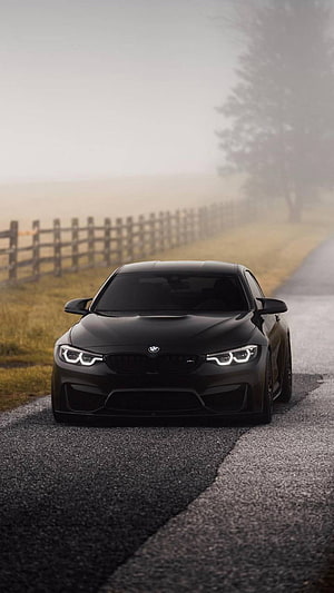 Matte Black BMW M4 Competition on a Foggy Country Road HD phone wallpaper
