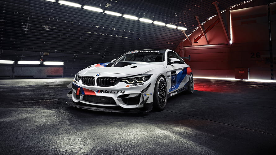 White BMW M4 GT4 Race Car in Dark Garage with Red Accent Lighting HD wallpaper