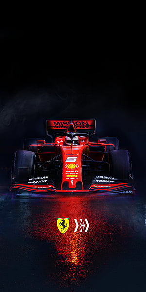 Ferrari Formula 1 Race Car Front View on Wet Track with Dramatic Red Lighting HD phone wallpaper