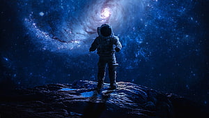 Astronaut Standing on Rocky Surface Gazing at Spiral Galaxy in Deep Space HD wallpaper