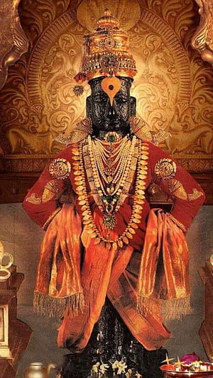 Ornate Black Stone Idol of Lord Shiva Adorned with Gold Jewelry and Red Silk Garments HD phone wallpaper
