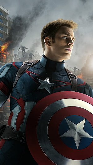 Captain America in Combat Gear Holding Shield Amidst Urban Destruction and Smoke HD phone wallpaper