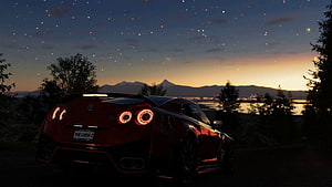 Red Nissan GT-R Nismo parked on a hill overlooking a city at twilight with a starry sky HD wallpaper