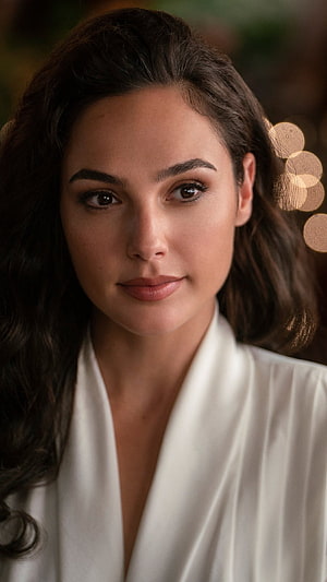 Gal Gadot Elegant Portrait in White Blouse with Warm Bokeh Background HD phone wallpaper