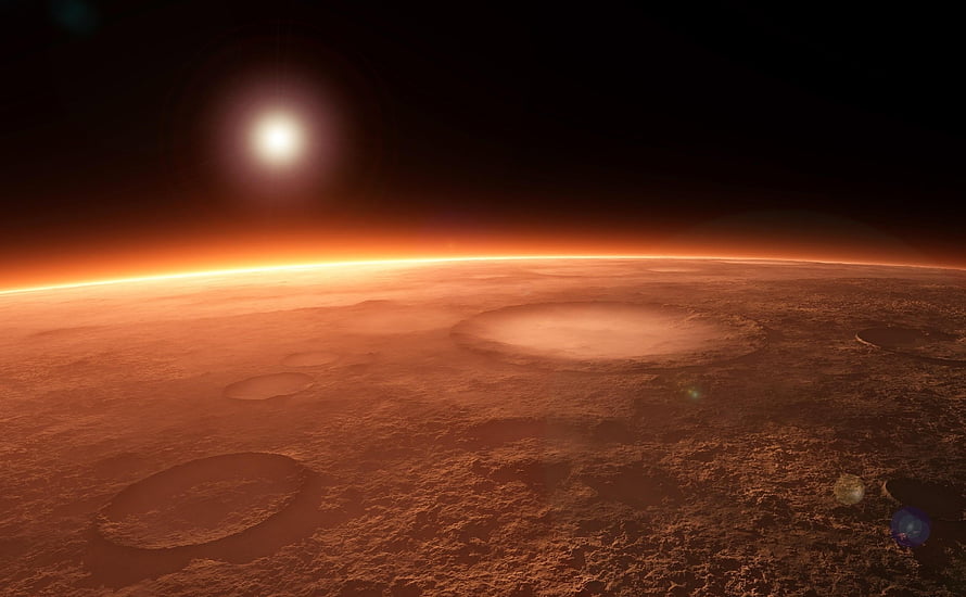 Mars Surface at Sunrise with Craters and Atmospheric Glow HD wallpaper