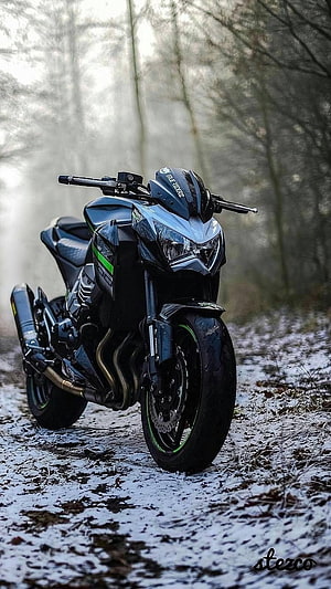 Kawasaki Ninja 400 sport bike parked on a snowy forest trail in winter HD phone wallpaper