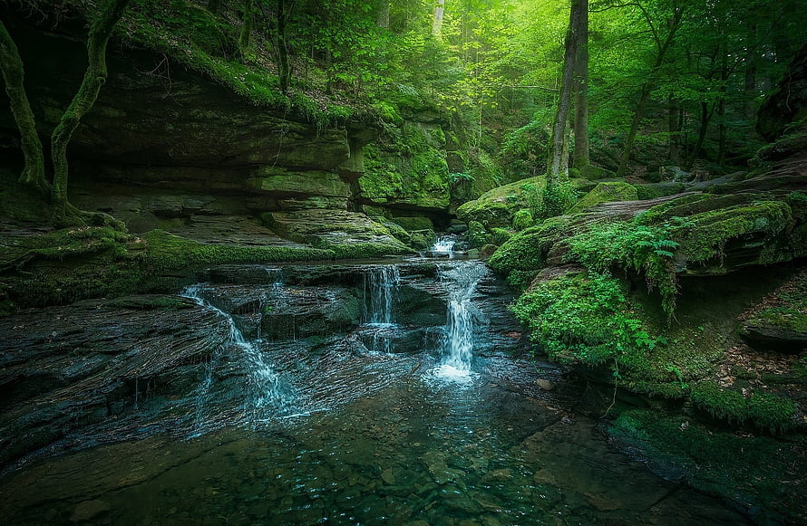Mossy Forest Waterfall Cascading Over Rocky Terrain in Lush Green Woodland HD wallpaper