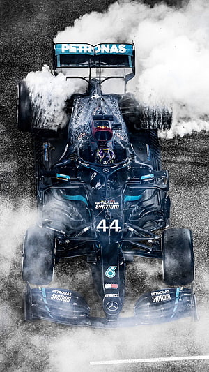 Lewis Hamilton Mercedes F1 Car Performing Burnout with Tire Smoke HD phone wallpaper