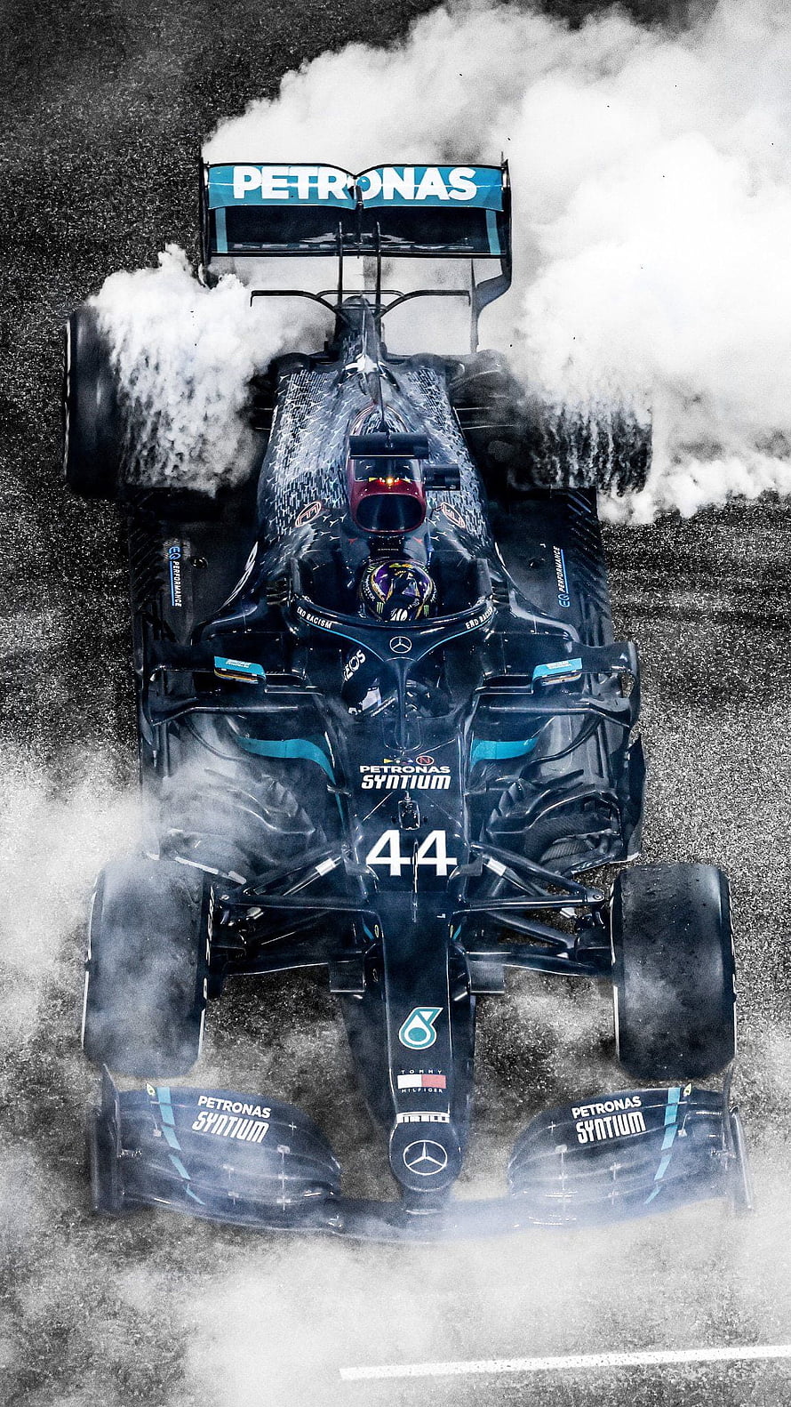 Lewis Hamilton Mercedes F1 Car Performing Burnout with Tire Smoke HD phone wallpaper