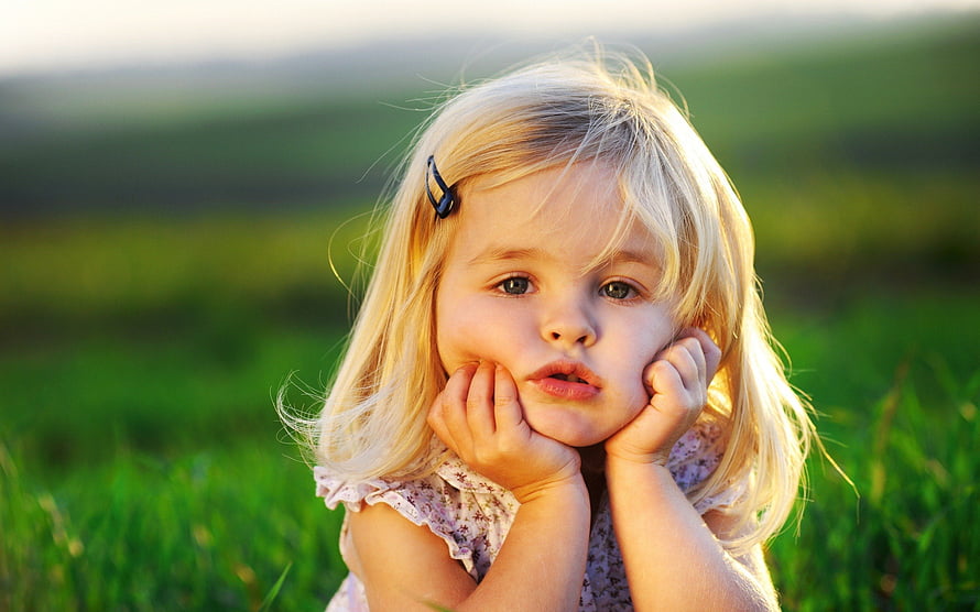 Adorable Blonde Toddler Girl Resting Chin On Hands In A Sunny Green Meadow HD wallpaper