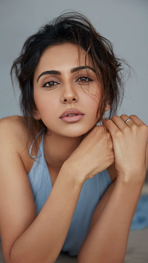 Portrait of Indian actress Rakul Preet Singh in a blue top with messy hair HD phone wallpaper