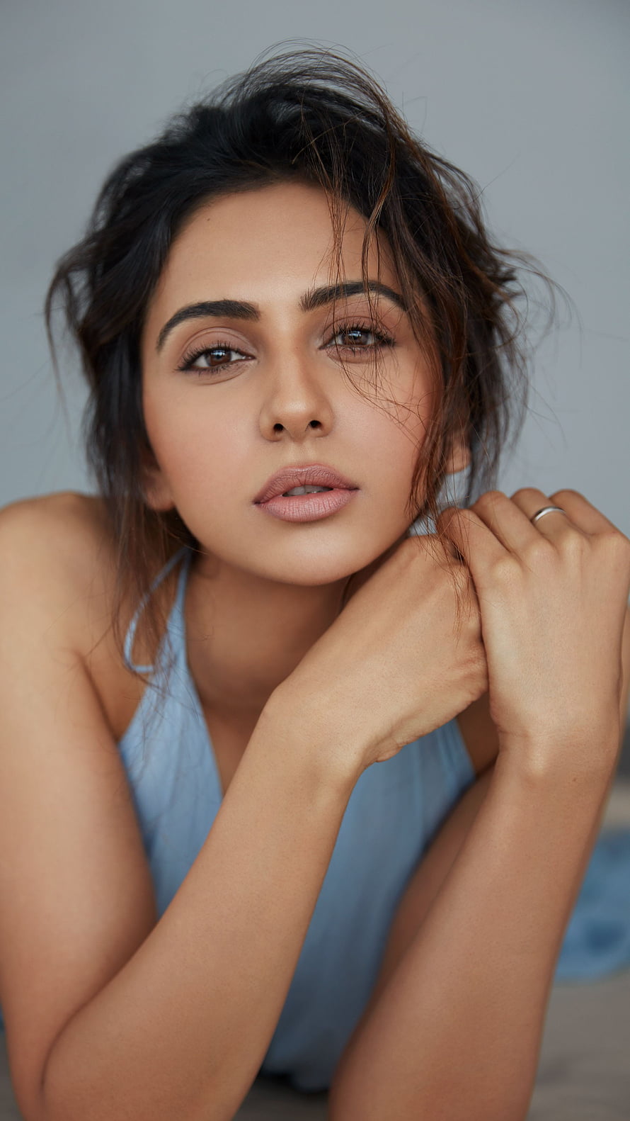 Portrait of Indian actress Rakul Preet Singh in a blue top with messy hair HD phone wallpaper