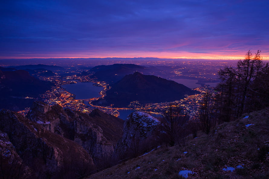Panoramic Twilight View of a City and Lake from a Mountain Ridge HD wallpaper
