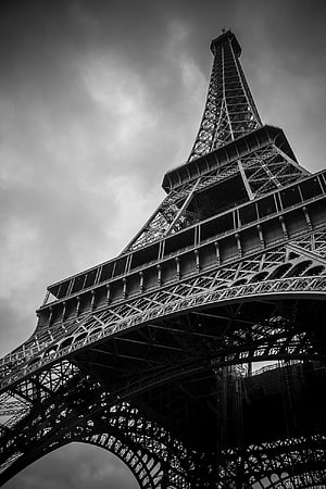 Dramatic Black and White Low Angle View of the Eiffel Tower Against a Moody Sky HD phone wallpaper