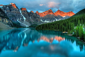 Maligne Lake at Sunrise with Reflections of the Canadian Rockies and Pine Forest HD wallpaper